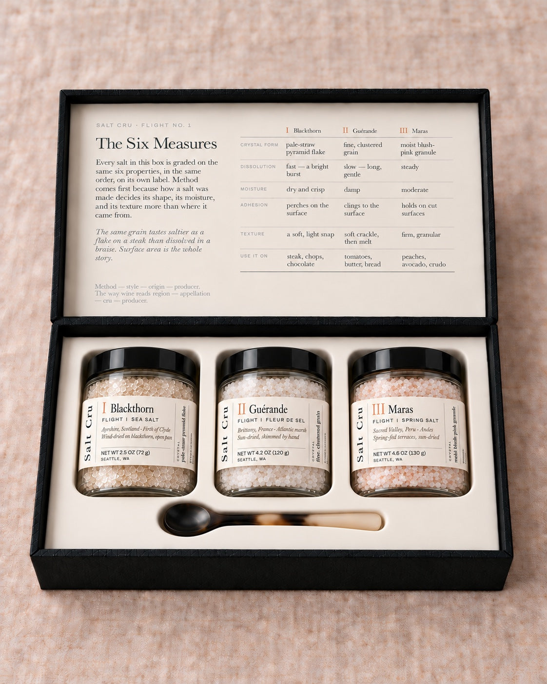 The open Salt Cru flight with three jars and an ox-horn spoon in a fitted case
