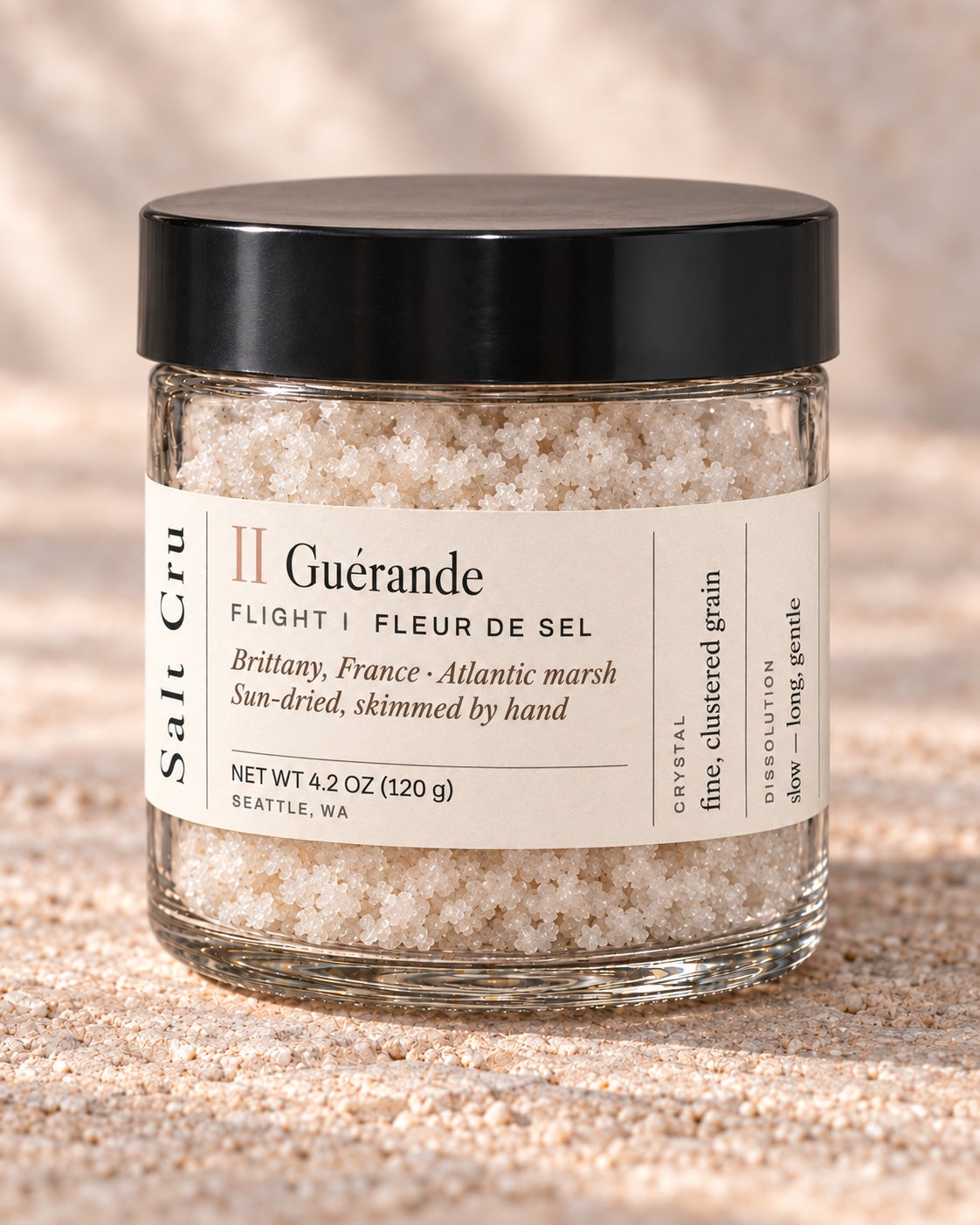 Fleur de sel de Guérande in the compact jar with the cream wrap label and broad black lid
