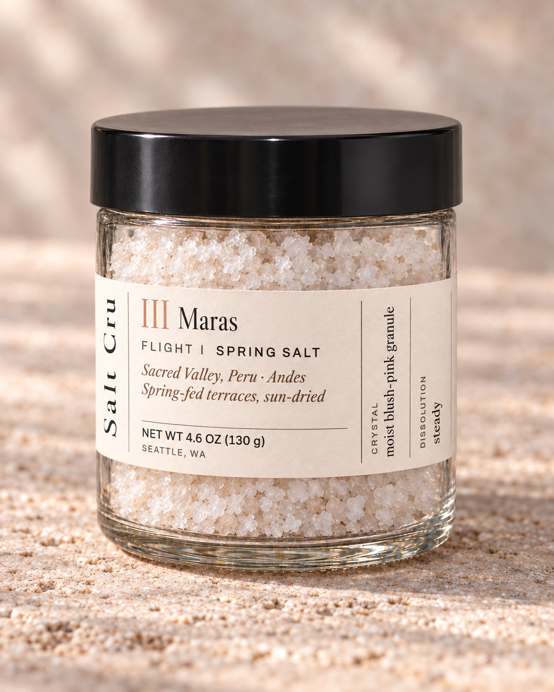 Maras finishing salt in the compact jar with the cream wrap label and broad black lid